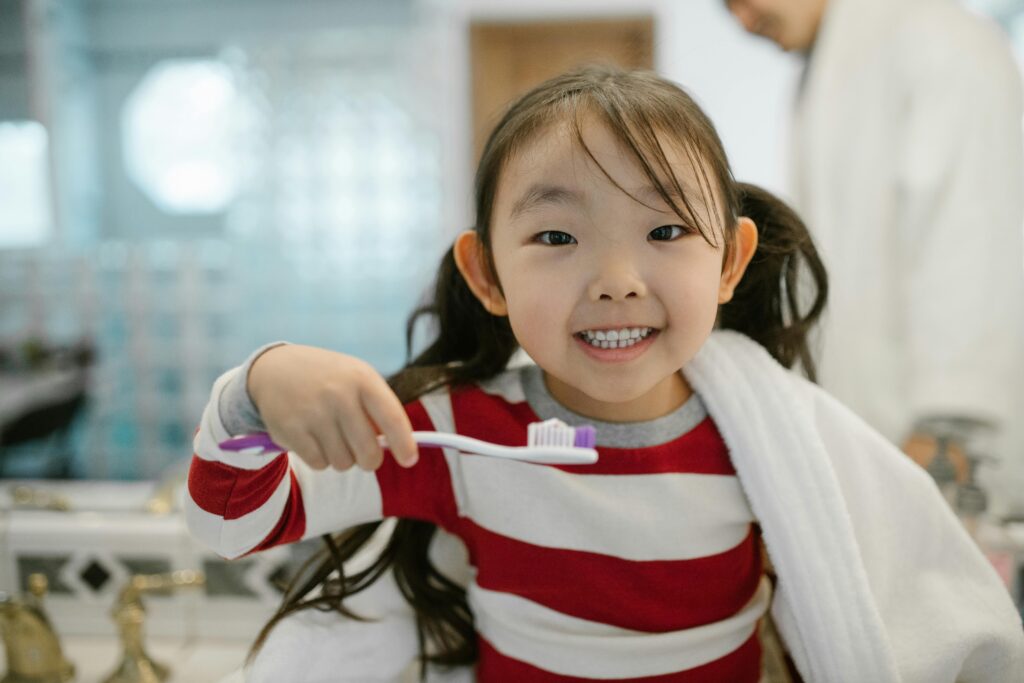 smiling girl ready to brush her teeth